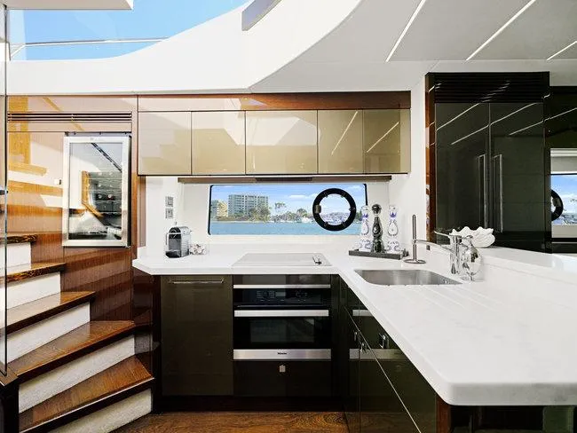 Slide: The Image of Luxurious kitchen interior on 2018 Sunseeker Predator 74 yacht, featuring modern appliances and sleek design. - 18