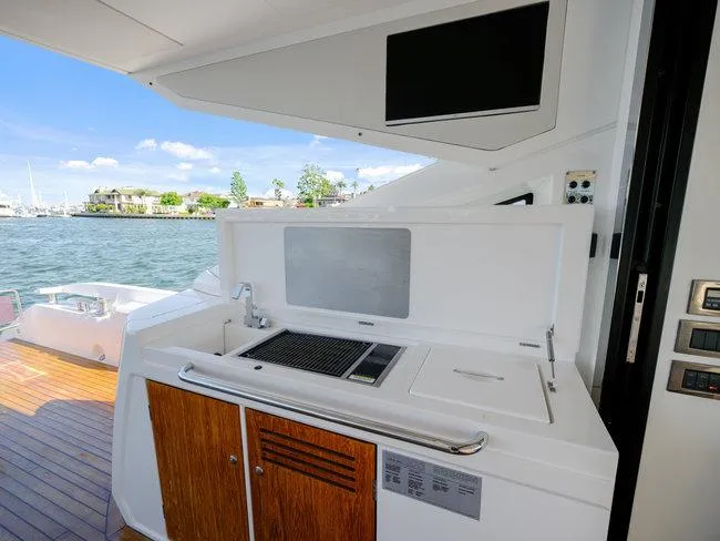 Slide: The Image of Outdoor kitchen on 2018 Sunseeker Predator 74 yacht with grill and sink, overlooking water. - 44
