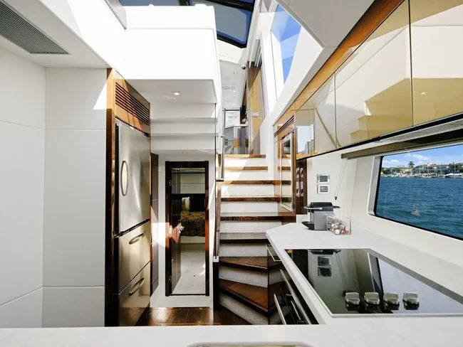 Slide: The Image of Luxurious interior of 2018 Sunseeker Predator 74 yacht with modern kitchen and staircase. - 16