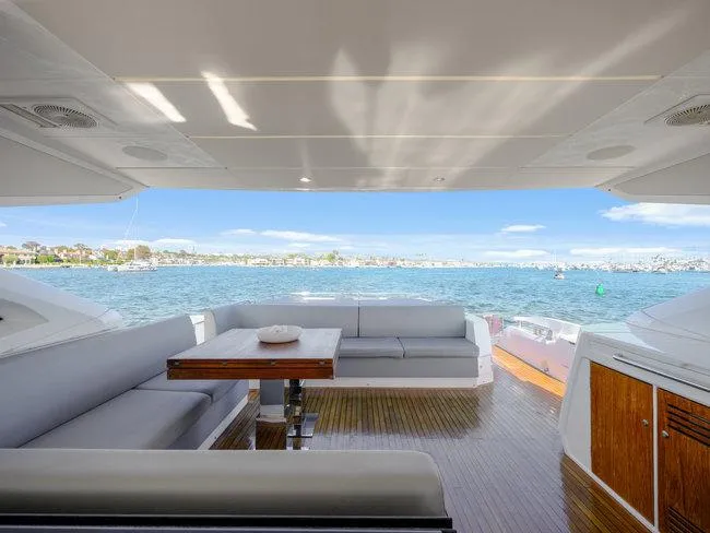 Slide: The Image of Sunseeker Predator 74 yacht interior with ocean view, featuring sleek seating and wooden accents. - 43