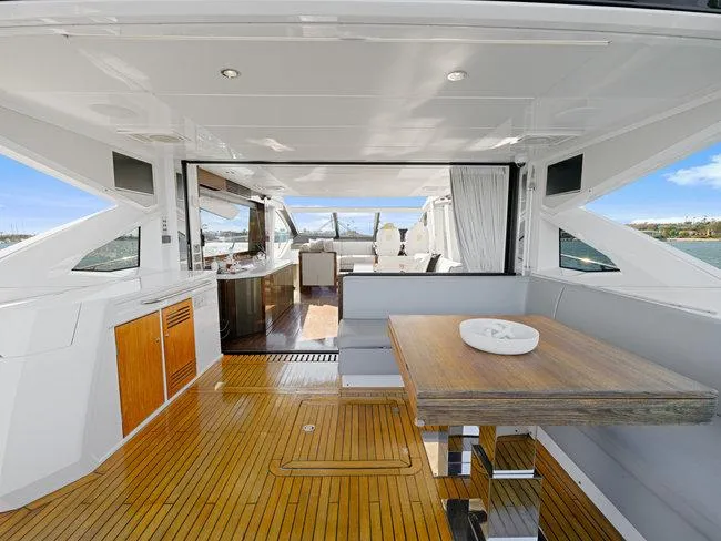Slide: The Image of Luxurious Sunseeker Predator 74 yacht interior, featuring elegant wood flooring and modern dining area. - 47