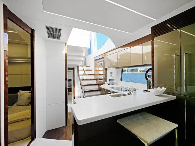 Slide: The Image of Luxurious interior of 2018 Sunseeker Predator 74 yacht with modern kitchen and staircase. - 14