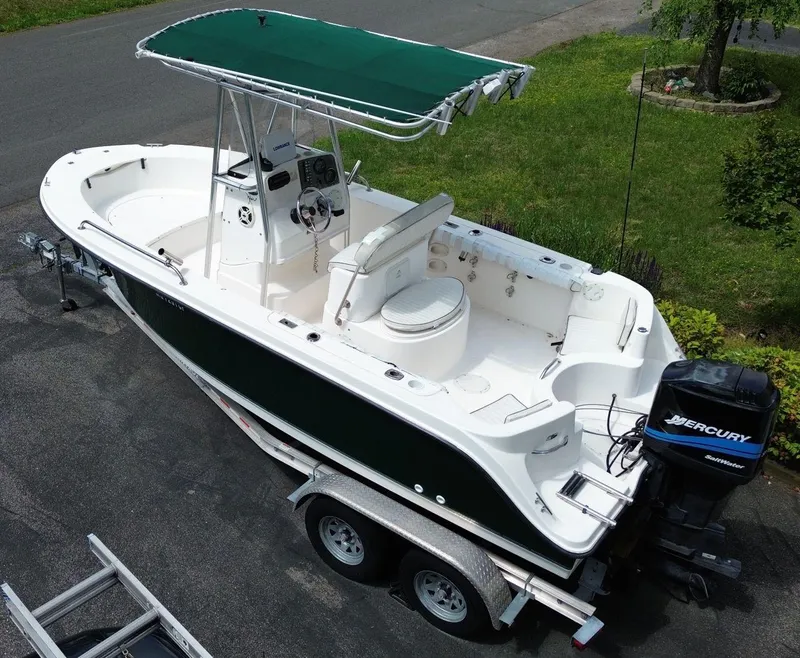 Slide: The Image of 2003 Trophy 1903 Center Console boat on trailer with green canopy and Mercury outboard motor. - 6