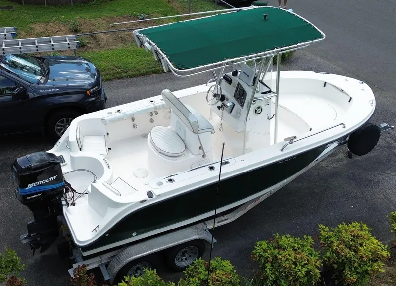 Slide: The Image of 2003 Trophy 1903 Center Console boat on trailer with green canopy and Mercury outboard motor. - 8