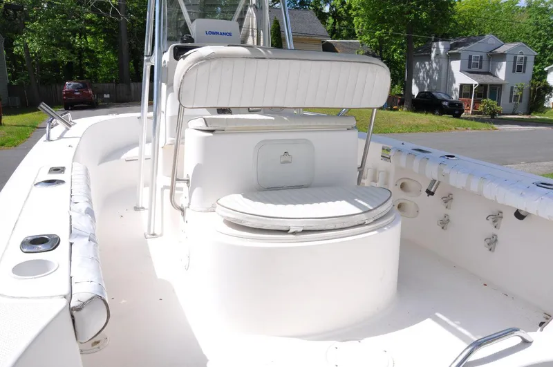 Slide: The Image of 2003 Trophy 1903 Center Console boat with seating and storage, parked in a residential area. - 9
