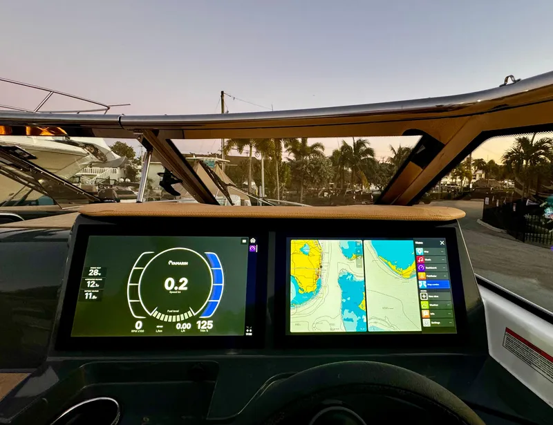 Slide: The Image of Dashboard of 2023 Yamarin 88 DC boat with navigation screens at sunset. - 11