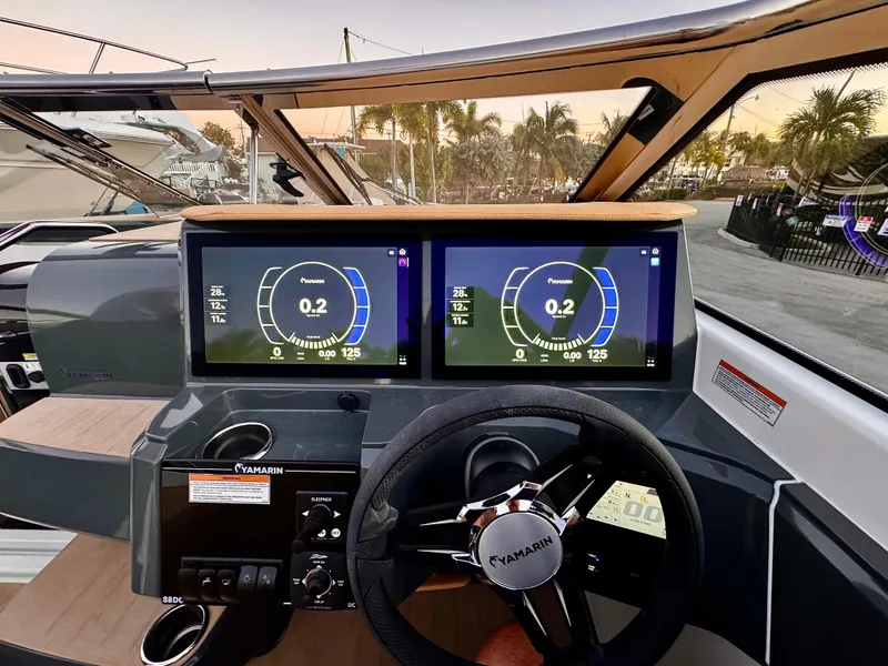Slide: The Image of 2023 Yamarin 88 DC boat dashboard with dual digital displays and steering wheel. - 12