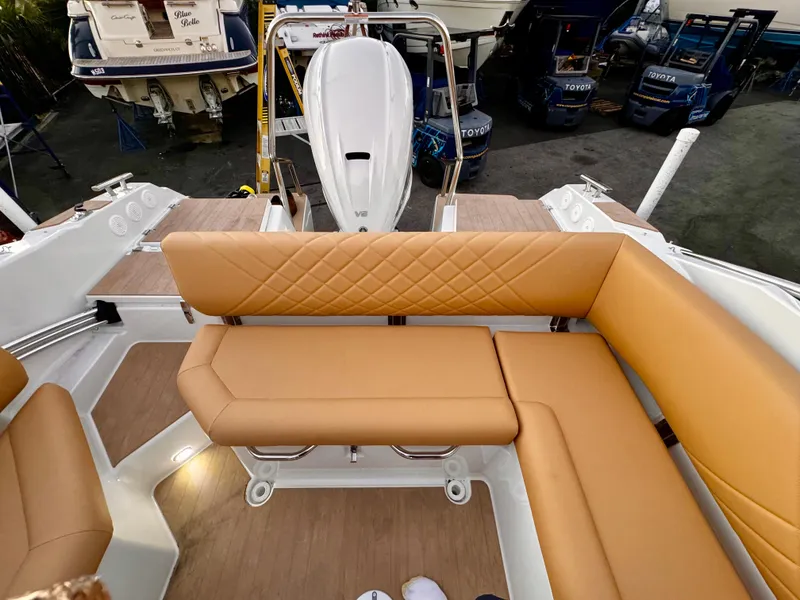 Slide: The Image of Luxurious seating on 2023 Yamarin 88 DC boat, featuring tan upholstery and modern design. - 18