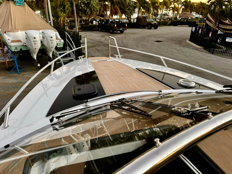 Slide: The Image of 2023 Yamarin 88 DC boat with sleek deck design, parked near marina. - 20