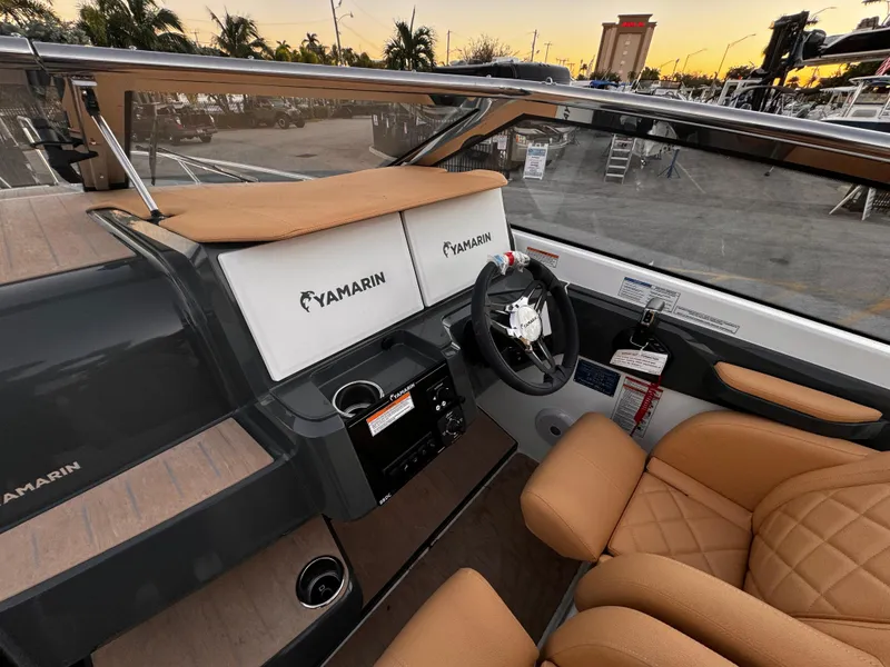 Slide: The Image of 2023 Yamarin 88 DC boat interior with tan seats and modern dashboard. - 24
