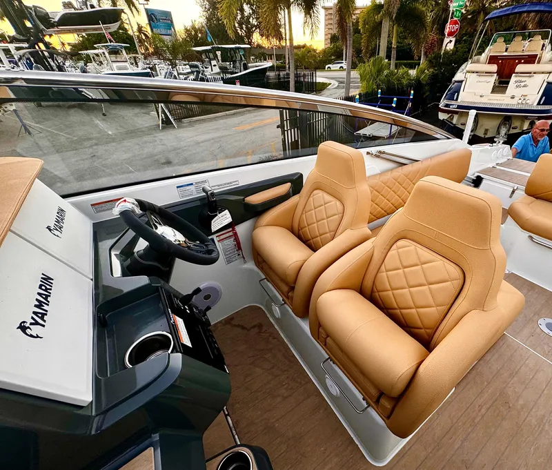 Slide: The Image of 2023 Yamarin 88 DC boat interior with tan leather seats and modern dashboard. - 26