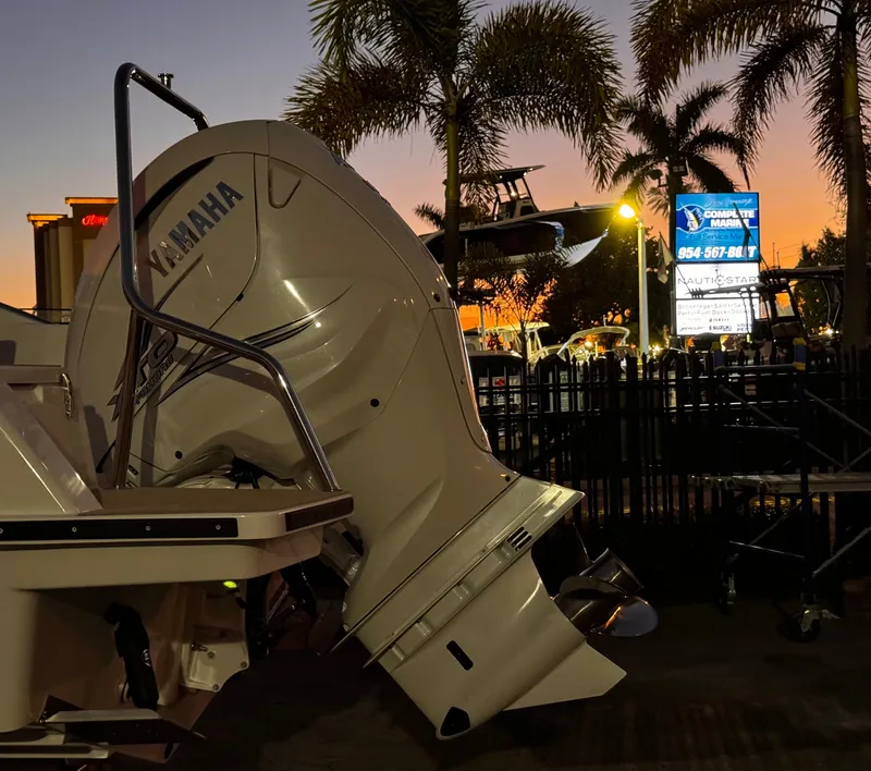 Slide: The Image of 2023 Yamarin 88 DC boat with Yamaha engine at sunset, palm trees in background. - 27