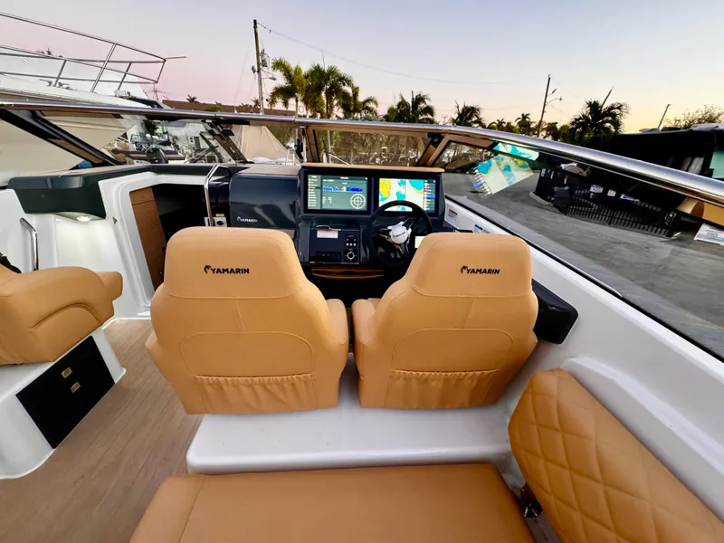 Slide: The Image of 2023 Yamarin 88 DC boat interior with tan seats and modern dashboard controls. - 3
