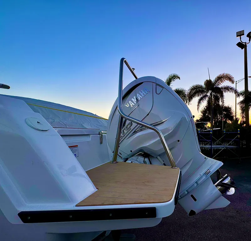 Slide: The Image of 2023 Yamarin 88 DC boat with Yamaha engine at sunset, palm trees in background. - 32