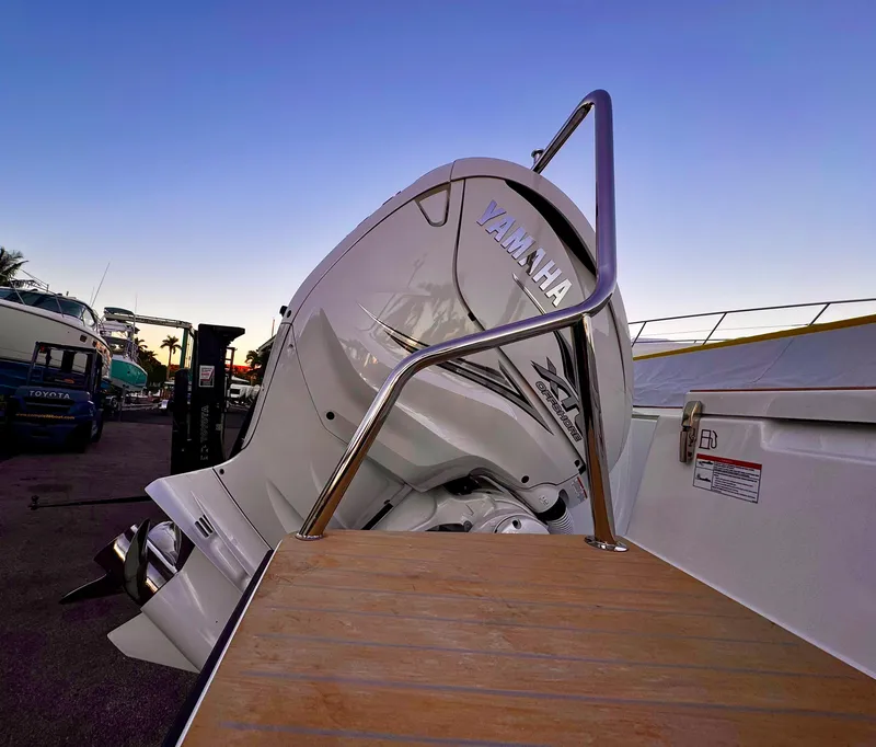 Slide: The Image of 2023 Yamarin 88 DC boat with Yamaha engine at sunset, docked with wooden platform. - 33