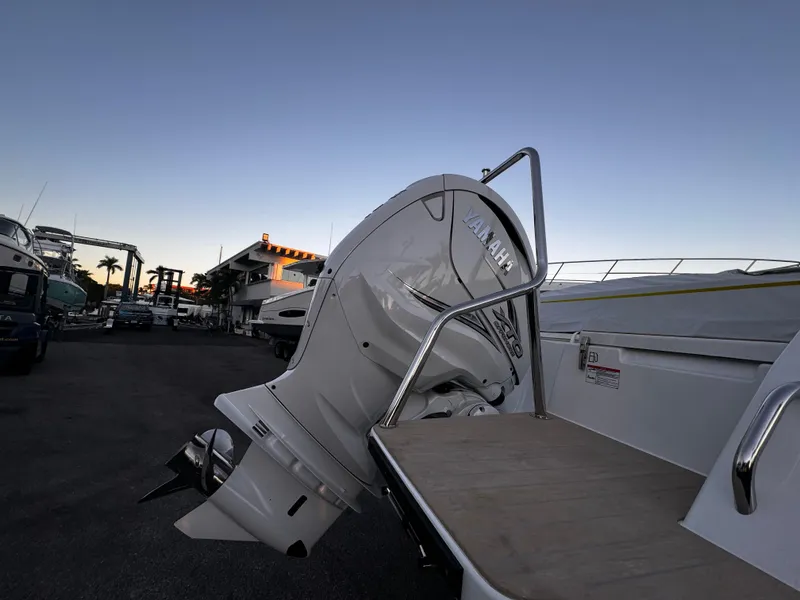Slide: The Image of 2023 Yamarin 88 DC boat with outboard motor at dock, evening sky backdrop. - 34