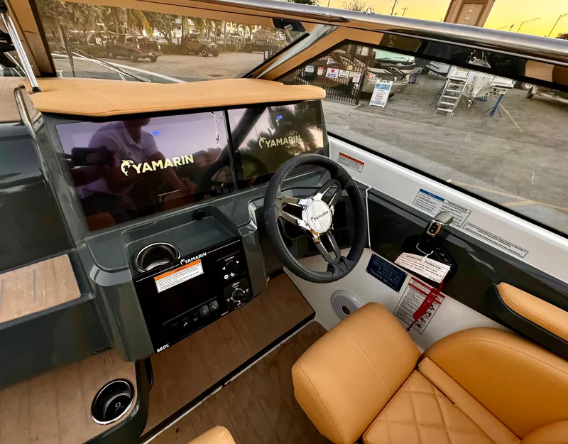 Slide: The Image of 2023 Yamarin 88 DC boat interior with modern dashboard and tan leather seating. - 38