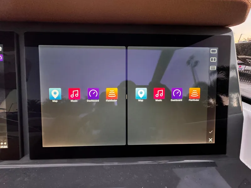 Slide: The Image of Touchscreen display in 2023 Yamarin 88 DC boat showing navigation and media apps. - 40