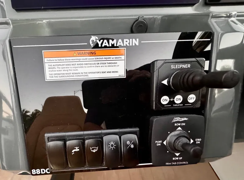 Slide: The Image of Control panel of 2023 Yamarin 88 DC boat with warning label and switches. - 42