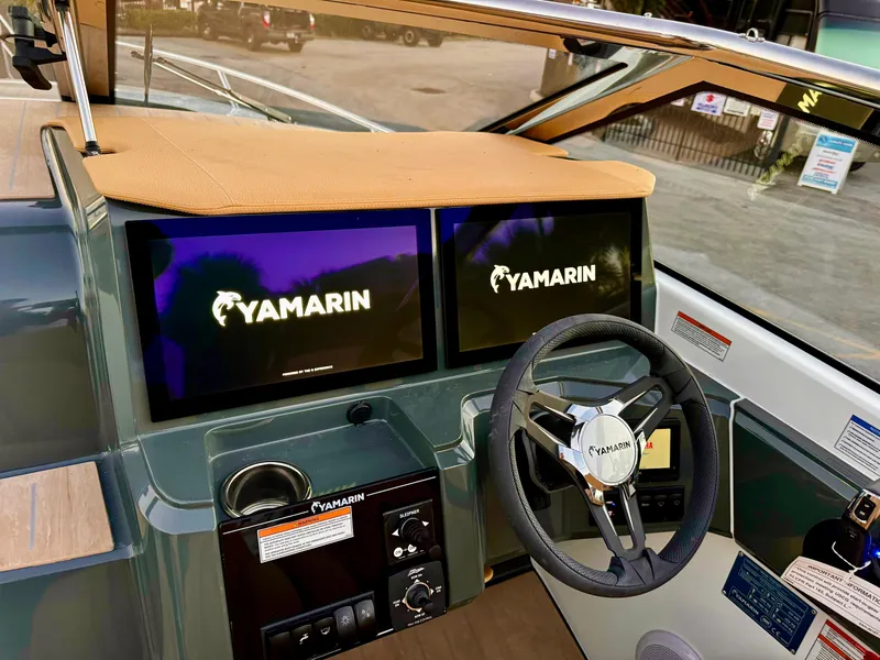 Slide: The Image of 2023 Yamarin 88 DC boat dashboard with dual screens and steering wheel. - 43