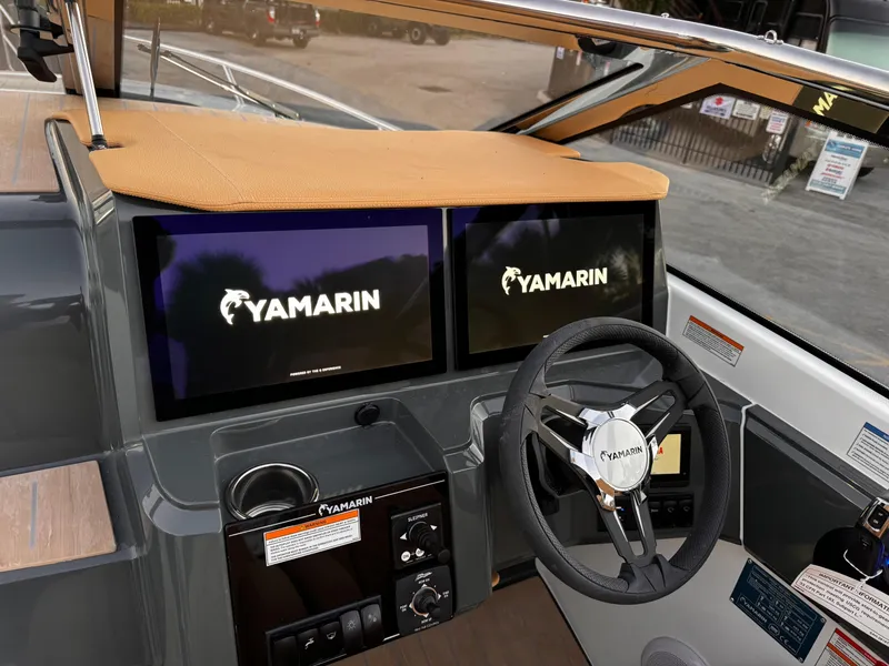 Slide: The Image of 2023 Yamarin 88 DC boat dashboard with dual screens and steering wheel. - 45