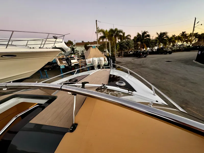 Slide: The Image of 2023 Yamarin 88 DC boat docked, surrounded by palm trees and other vessels. - 46