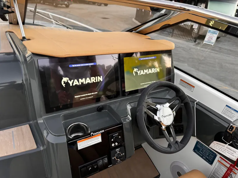 Slide: The Image of 2023 Yamarin 88 DC boat dashboard with dual screens and steering wheel. - 49