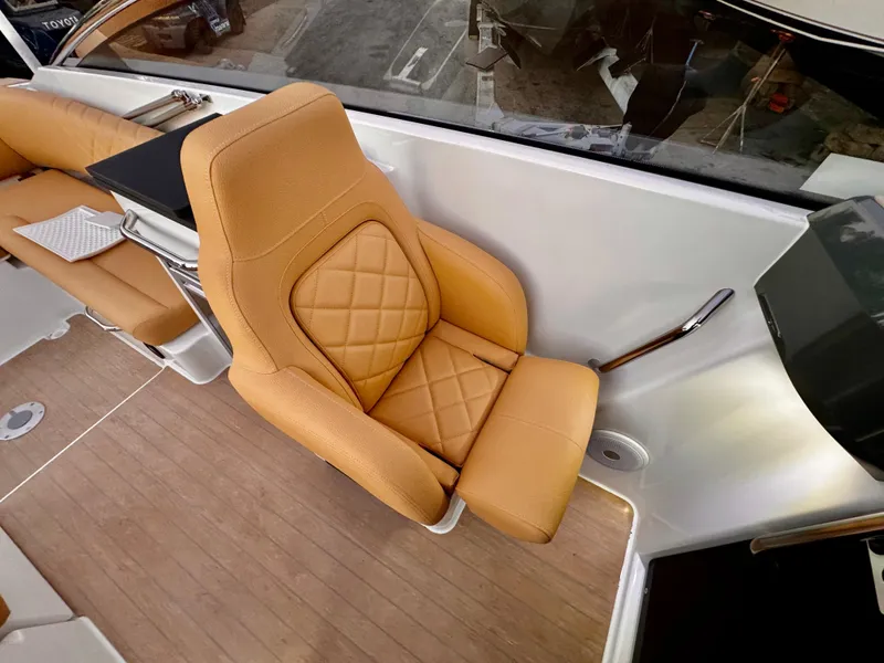 Slide: The Image of Luxurious seating on 2023 Yamarin 88 DC boat, featuring tan leather upholstery and modern design. - 5