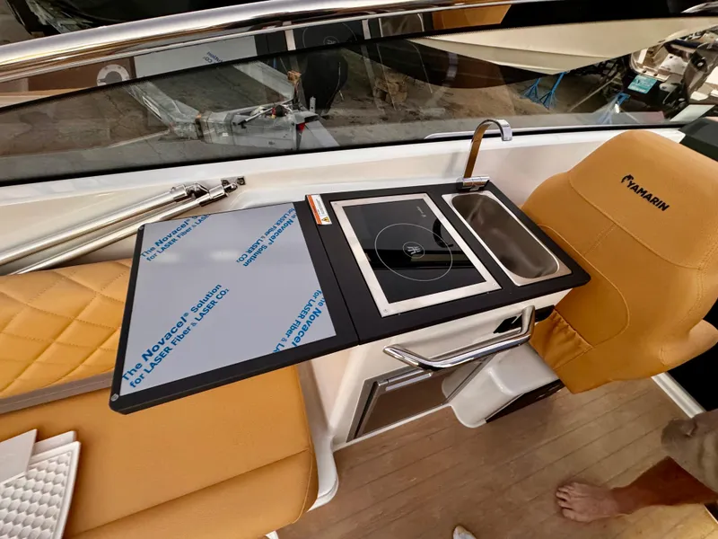 Slide: The Image of 2023 Yamarin 88 DC boat interior with kitchenette, featuring a sink and stove. - 7