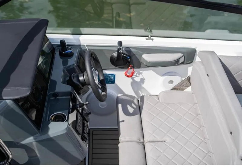 Slide: The Image of 2025 Yamarin 80DC boat interior with steering wheel and quilted seating. - 22