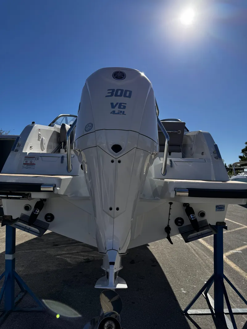 Slide: The Image of 2025 Yamarin 80DC boat with powerful 300 V6 engine, displayed under clear blue sky. - 24