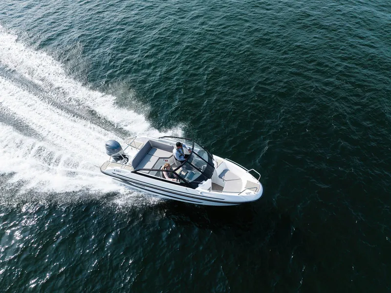 Slide: The Image of 2026 Yamarin 59 boat cruising on open water, aerial view. - 2