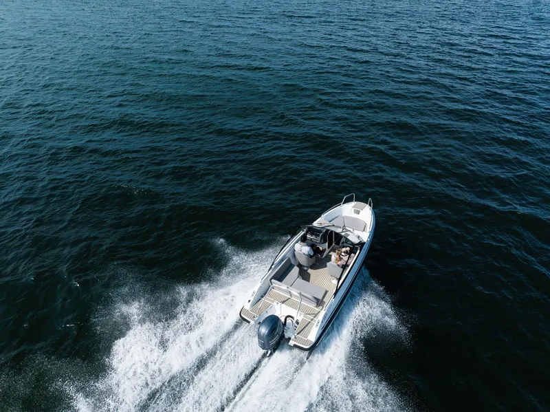 Slide: The Image of 2026 Yamarin 59 boat cruising on open water, aerial view. - 3