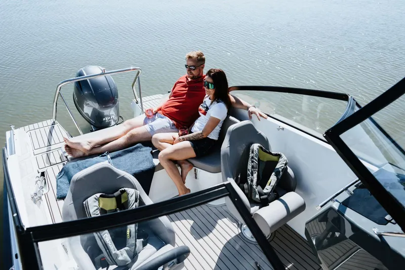 Slide: The Image of Couple relaxing on a 2026 Yamarin 59 boat, enjoying a sunny day on the water. - 4
