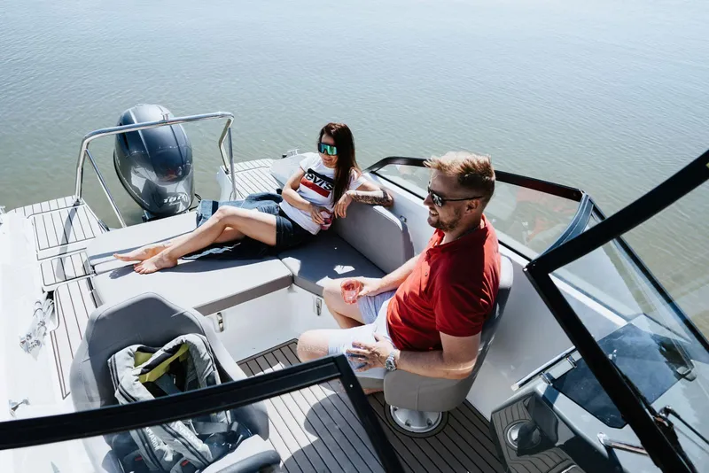 Slide: The Image of Two people relaxing on a 2026 Yamarin 59 boat in sunny weather. - 5