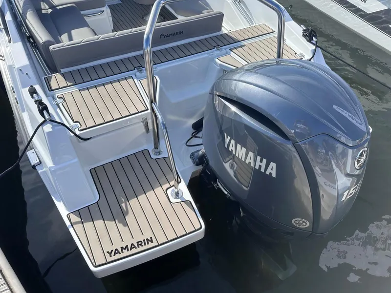 Slide: The Image of 2026 Yamarin 63 boat with Yamaha engine, featuring sleek design and wooden deck accents. - 2