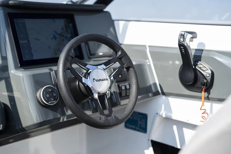 Slide: The Image of 2026 Yamarin 63 boat dashboard with steering wheel and control panel. - 4