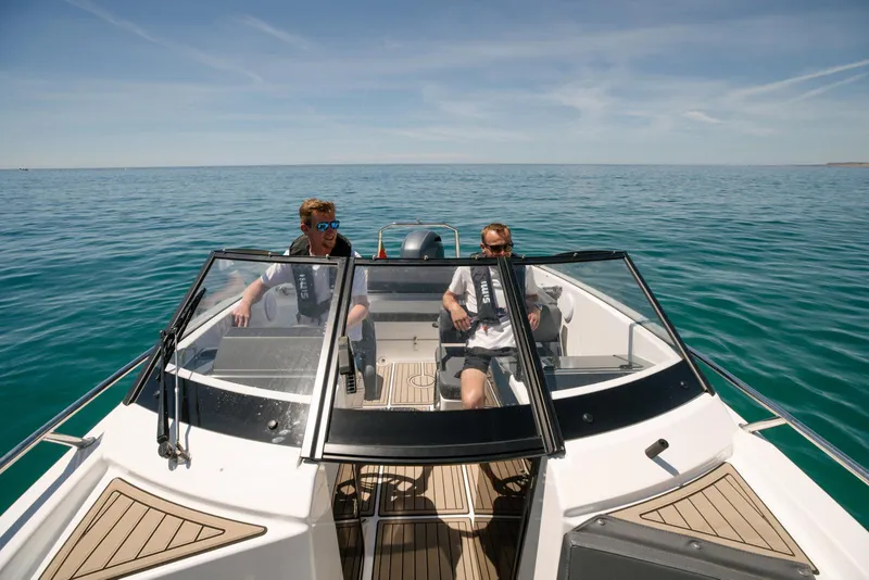 Slide: The Image of 2026 Yamarin 63 boat with two people cruising on open water. - 5