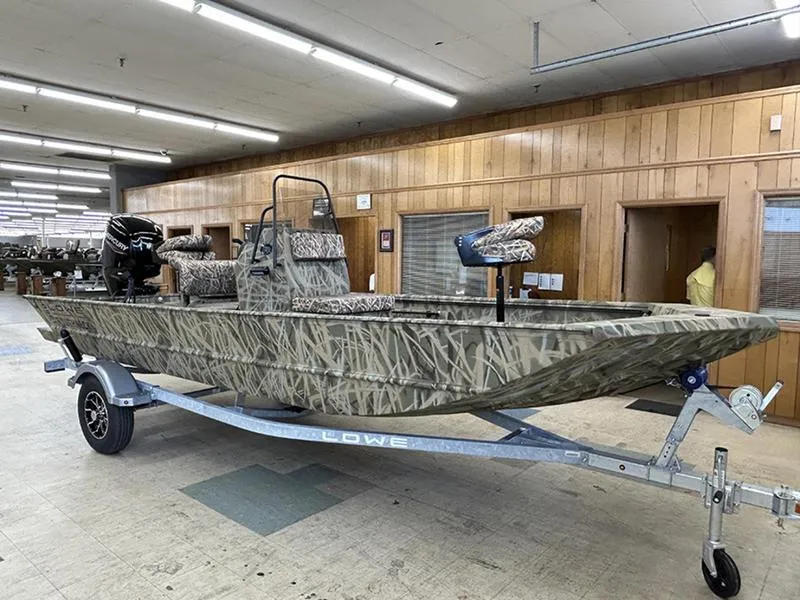 Slide: The Image of 2025 Lowe RX1860 CC boat with camouflage design on a trailer indoors. - 0