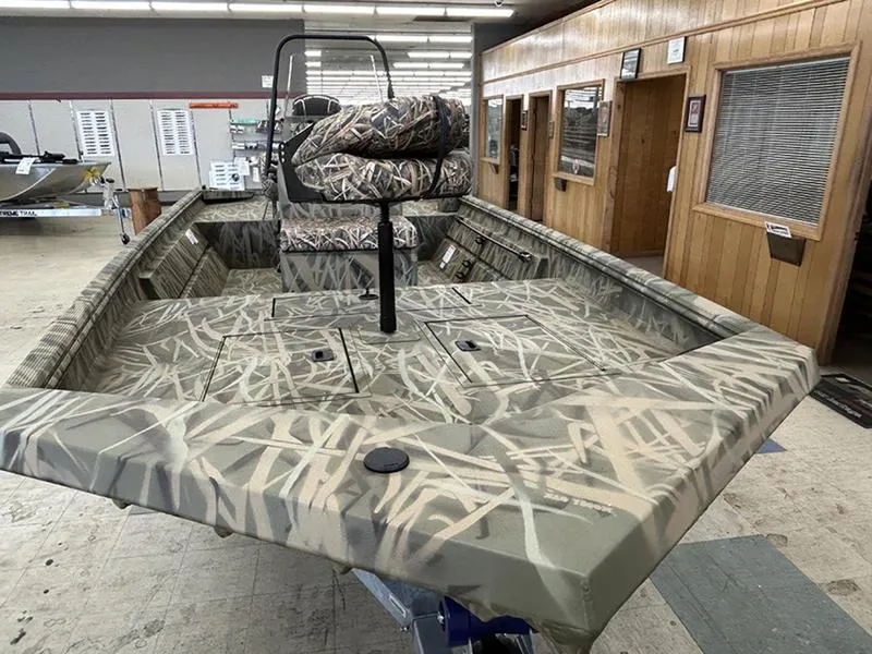 Slide: The Image of 2025 Lowe RX1860 CC boat with camouflage design in showroom. - 8