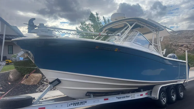 The Image of 2021 Grady-White Freedom 275 boat on trailer, cloudy sky. - 0