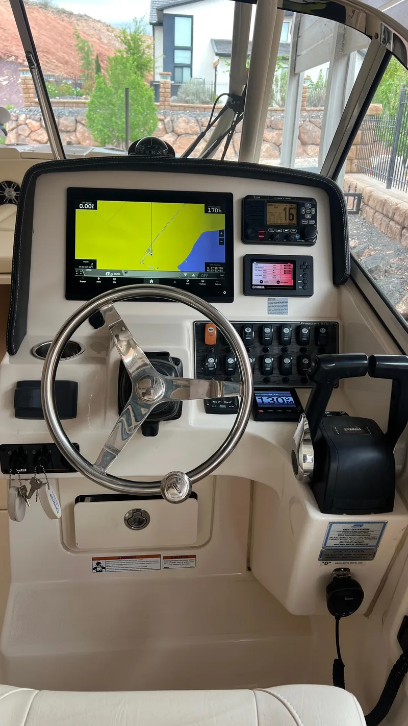 Slide: The Image of Helm console of a 2021 Grady-White Freedom 275 boat. - 14