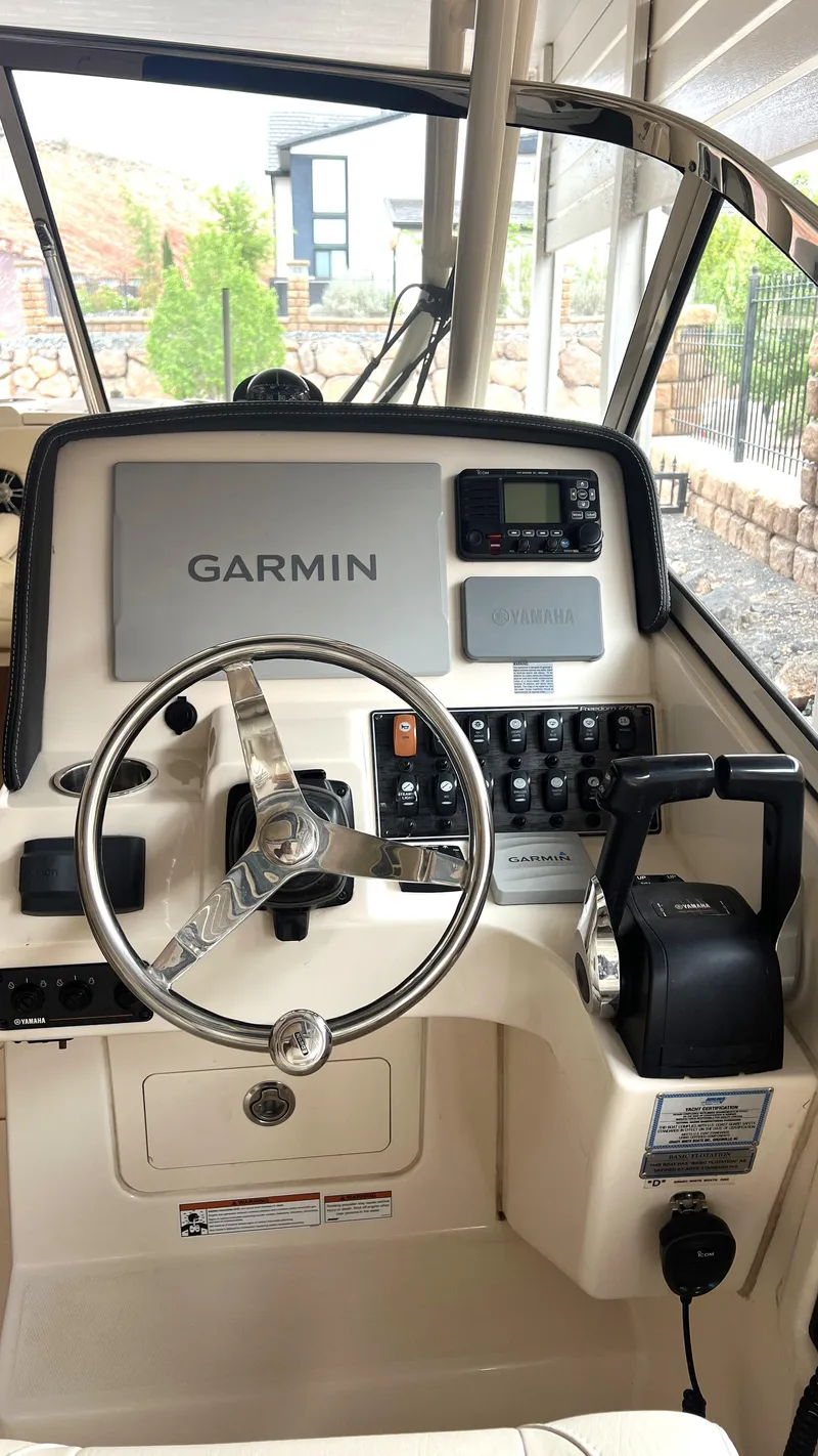 Slide: The Image of Helm of a 2021 Grady-White Freedom 275 boat with Garmin system. - 15