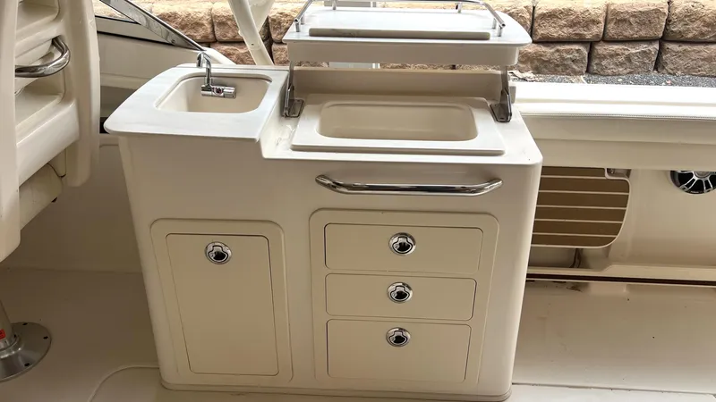 Slide: The Image of Grady-White Freedom 275 2021 boat kitchenette with sink and storage. - 20