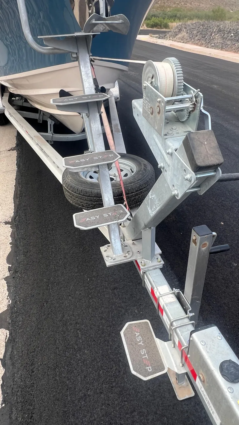 Slide: The Image of Grady-White Freedom 275 boat trailer, 2021 model, on asphalt road. - 8