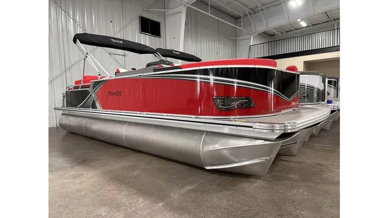 Slide: The Image of 2025 Tahoe Pontoon LTZ Quad Lounger Shift in a showroom, featuring sleek red design. - 0
