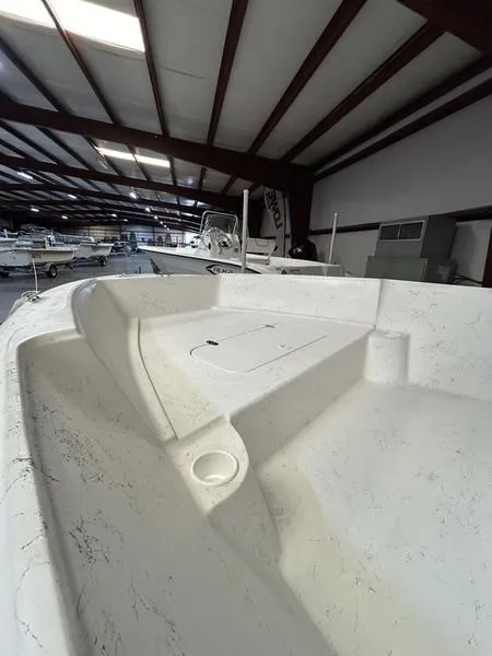 Slide: The Image of 2024 ALK2 Powerboats 22 CRS interior, showcasing spacious deck in a well-lit showroom. - 4