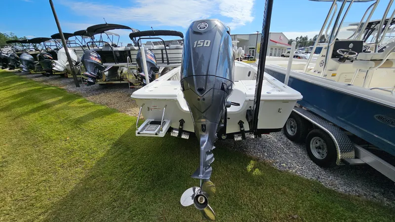 Slide: The Image of 2024 Sea Pro 210 Bay boat with 150 HP engine displayed outdoors. - 10