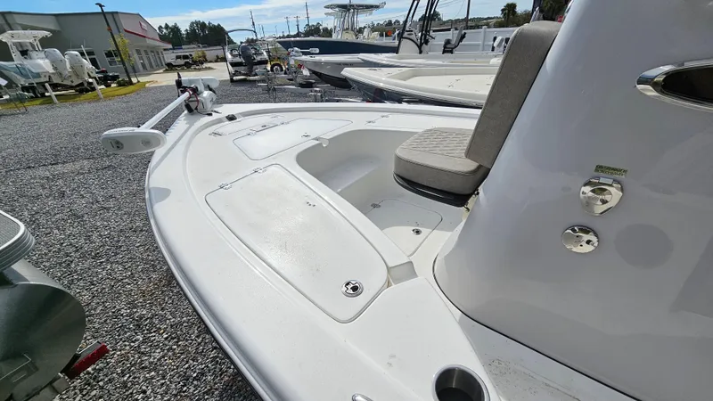 Slide: The Image of 2024 Sea Pro 210 Bay boat, white deck, outdoor display, gravel lot. - 16