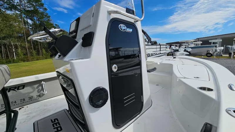 Slide: The Image of 2024 Sea Pro 210 Bay boat, white exterior, sleek design, outdoor setting, clear blue sky. - 4